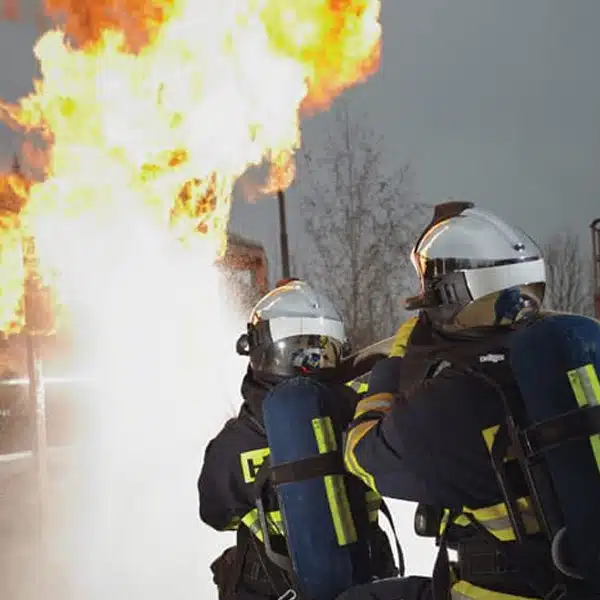 Firefighters Wearing Dräger HPS 7000 Outside Building